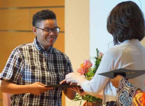 A student receiving an award at a ceremony. 